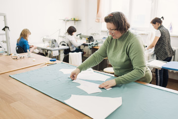 Obraz premium tailors work in the shop for the production of clothing
