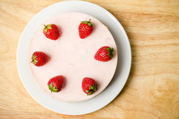 Homemade strawberry cheesecake  on white plate