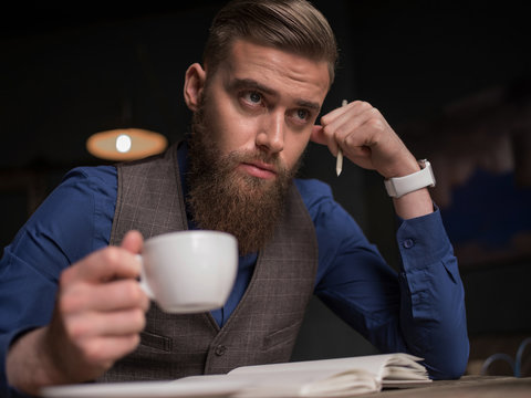 Handsome bearded guy is trying to write something