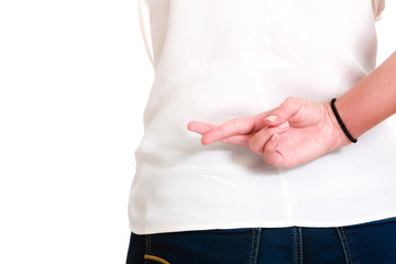 Hispanic young woman wishing luck with fingers crossed on the back.