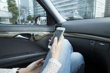 Young women are to navigation in the front passenger seat of the car