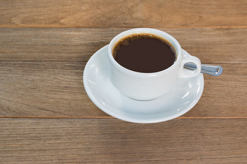 Cup of coffee on wooden table