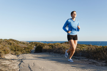 Sport runner jogging on beach working out