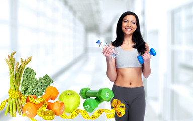 Healthy woman with dumbbell.