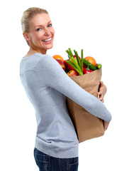 Beautiful woman holding shopping bag with food.