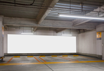 Parking garage underground interior with blank billboard