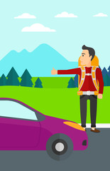 Young man hitchhiking.