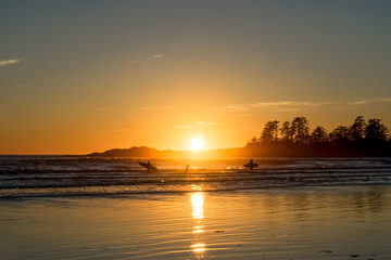 Family surfing at Chesterman Beach near Tofino, British Columbia