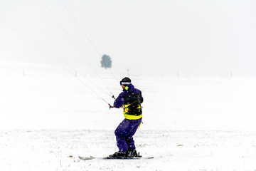 Fototapeta na wymiar Man kite skiing