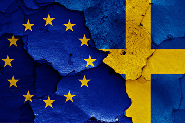 flags of EU and Sweden painted on cracked wall