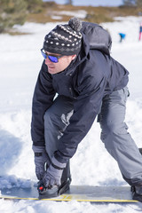 Close-up of man wearing snowboard