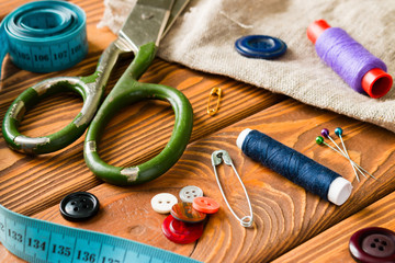 Fototapeta na wymiar Sewing Accessories on wooden background closeup