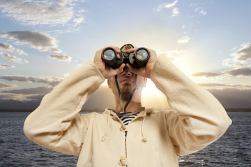 Captain looks through a binoculars