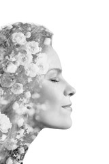 Creative portrait of beautiful young woman made from double exposure effect using photo of roses flowers, isolated on white background, monochrome