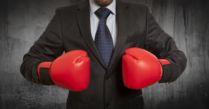 Businessman in red boxing gloves