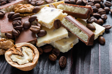 broken chocolate on a background of coffee and walnut selective focus