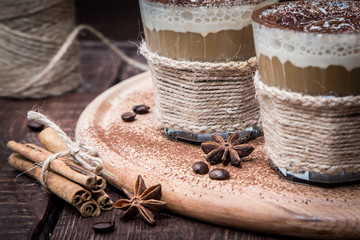 Delicious coffee with cream and cocoa, selective focus and toned