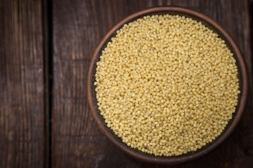 hulled millet on a dark background