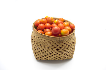 Cherry tomatoes in basket on white background