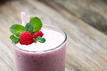Raspberry milk shake with mint decor.