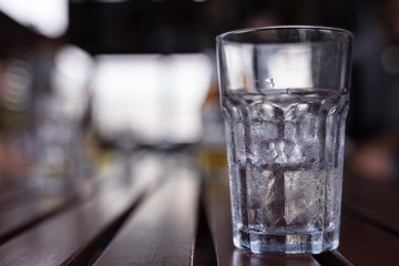 A glass of ice with water drop condense around it. Party, drink and loneliness