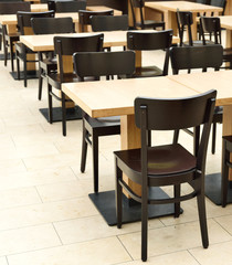 Restaurant furniture. Empty dining hall, fast food restaurant or canteen. Indoor shot with no people.