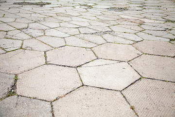 An old pavement of big concrete gray tiles background
