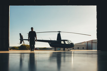 Pilot walking away from helicopter