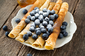 pancakes with blueberries on wooden surface
