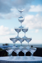 Pyramid of glasses on a background of blue sky