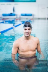 Handsome man wearing swim cap and goggles