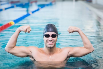 Handsome man triumphing with raised arms