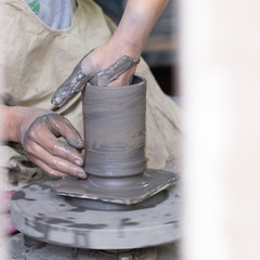 Artisan hands making clay pot