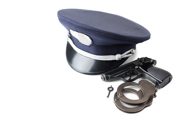Obraz premium police cap gun and handcuffs isolated on white background