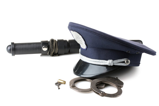 police baton with cap and handcuffs isolated on white background