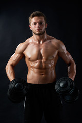 Portraying masculinity. Cropped shot of a ripped fitness man working out with dumbbells showing off his muscles