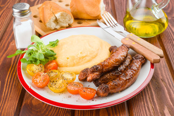 Pure plate with sausage and salad on rustic wood