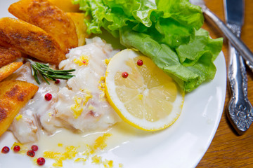 Lemon baked Haddock with fried Popapoes. Lemon sause,