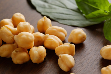 chickpeas  on the wooden surface and basil