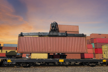 forklift handling and train  with container in shipyard for Logistic Import Export background sunset