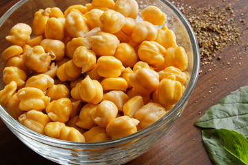 chickpeas  on the wooden surface and basil