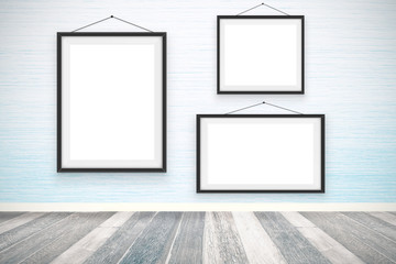 Blank picture frames on the wooden wall room
