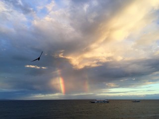 Rainbow in a sea during sunset