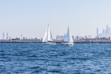 Fototapeta premium background seascape two sailboat met in the Gulf opposite the Dubai Marina in Dubai