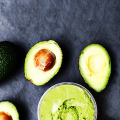 Avocado with Bowl of Guacamole on a black background top view image