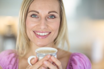 Pretty blonde woman having coffee