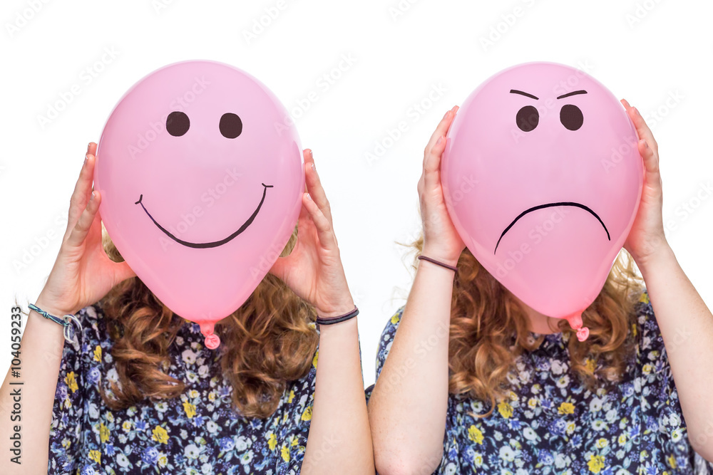 Wall mural two girls holding pink balloons with facial expressions for head