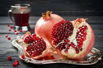 Pomegranate juice and pomegranate on a dark background