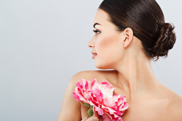 Young girl wearing white rowel and holding flower