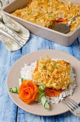 Oven-roasted fish fillet with carrots under a bread crust